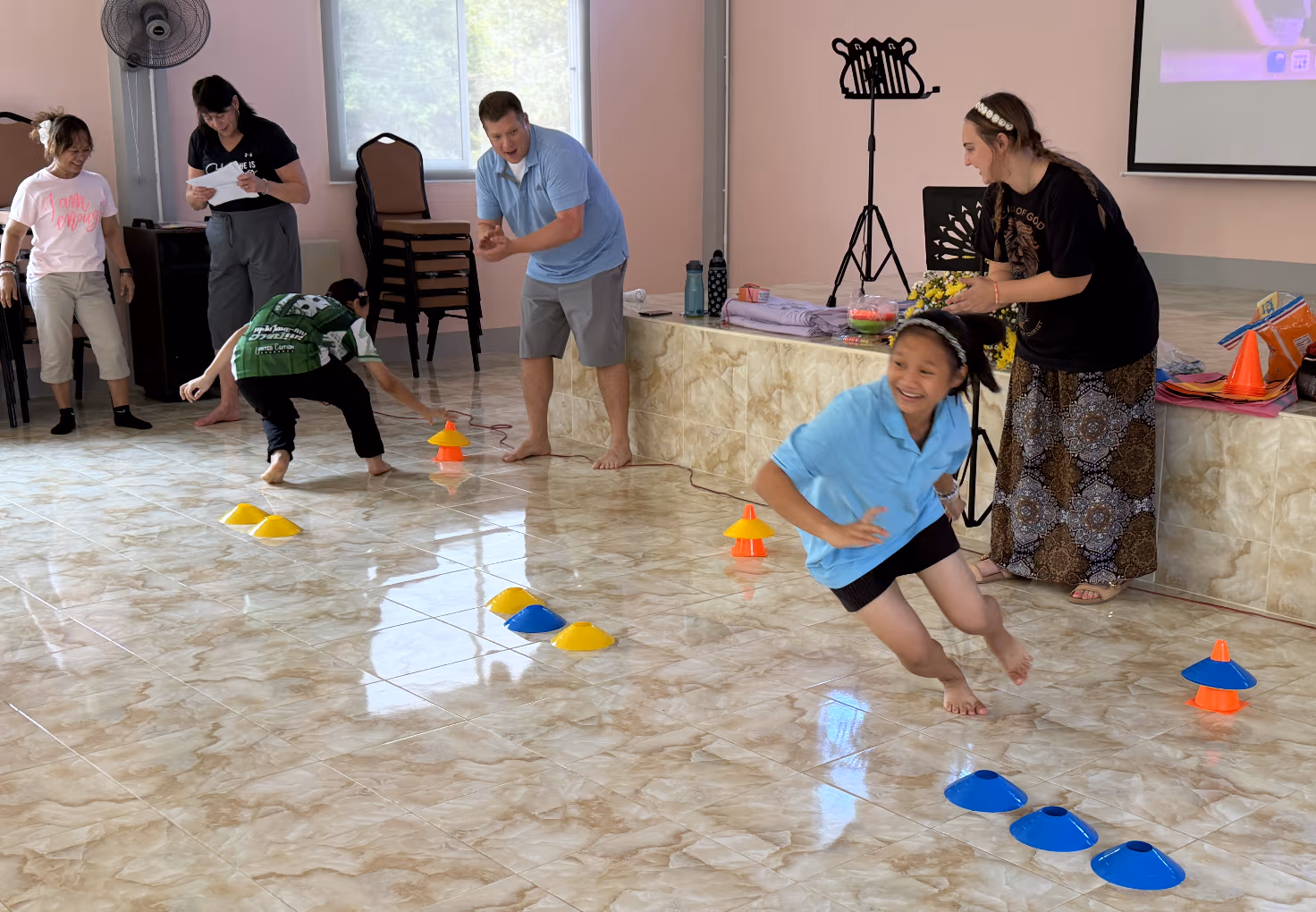 Girls playing relay games together at Faith House